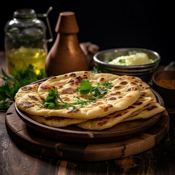 Indian naan bread with herbs and spices on a wooden background.