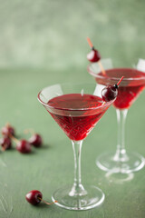 Cherrytini. Red alcoholic cherry martini cocktail with cherry garnish in martini glasses