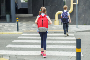 Premium Vector  School kids with backpack walking crossing road