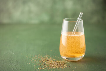 Club-Mate in glass on the table. Caffeinated carbonated mate extract sparkling drink
