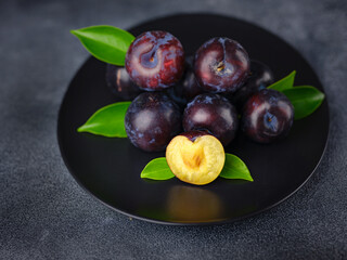 Sweet plums on dark background