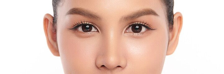 Fototapeta premium Close-up shot of beautiful Asian woman's eyes on white background.