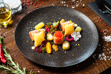 Salted Scottish salmon with trout roe. Marinated cucumber and onion, wonton chips. Delicious healthy Italian traditional food closeup served for lunch in modern gourmet cuisine restaurant