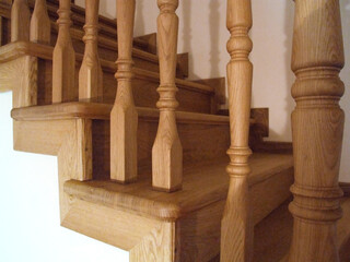 Wooden steps with traditional balusters indoors.