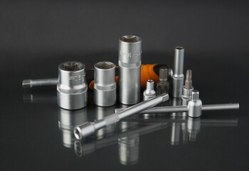 a set of hand tools on a mirror background
