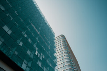 Contemporary residential buildings exterior in the daylight. Modern European residential apartment and office buildings quarter on a sunny day. Skyscrapers against blue sky, bottom view. 