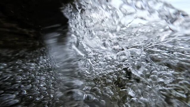 Sea waves crash on the rocks creating splashes