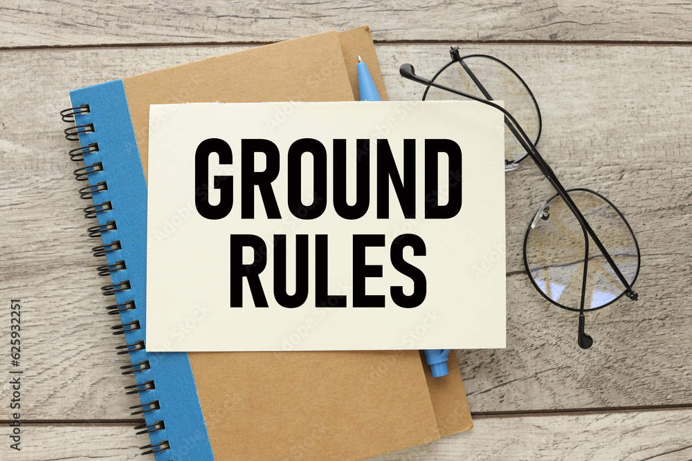 Poster notebook with a blue stripe and glasses on the notebook. ground rules