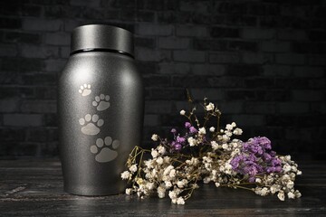 In remembrance of a pet. Pet urn beside a flower bouchet. 