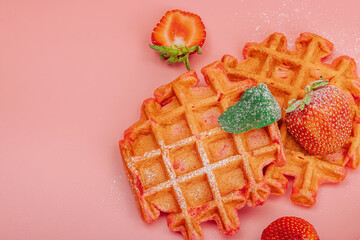Homemade Belgian Waffles with strawberries. Gluten-free red dessert, fresh fruits and basil