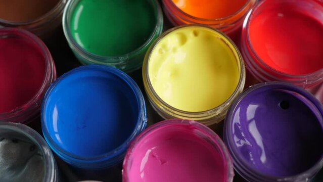 Set Gouache Paints in Jars Bright Color Close Up. Rotation Set of Multicolor Gouache on Plastic Jars. Rotation Multicolor Background. Background of Multi Colored Paint. Creative Drawing Art Hobby.