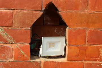 Foot light or spot light kept inside niche of a brick wall to give a classic look , foot light for...