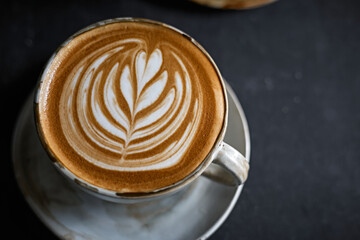 hot latte art coffee on dark background