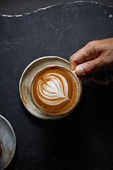 hot latte art coffee on dark background