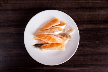 salmon slices on white plate.
