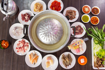 Chonburi Thailand - April 8 2023 : Thai food style. shabu sukiyaki or Moo-Ka-Ta griiled pork.