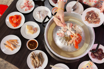 Chonburi Thailand - April 8 2023 : Thai food style. shabu sukiyaki or Moo-Ka-Ta griiled pork.