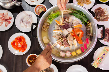 Chonburi Thailand - April 8 2023 : Thai food style. shabu sukiyaki or Moo-Ka-Ta griiled pork.