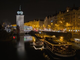 Prague at night. Many residential houses on the Vltava River and Current Ships anchored by the water tower and the Mánes Gallery © milava