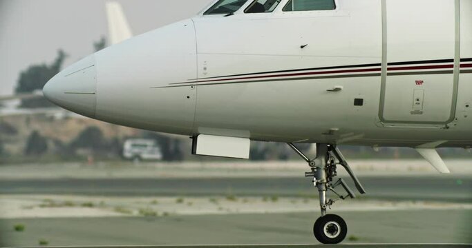 A private jet takes off from the airport parking lot onto the runway. Business flights. High quality 4k footage