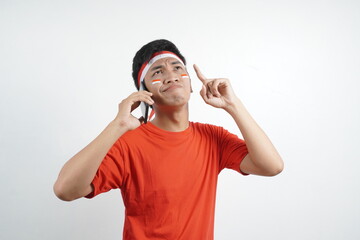 Asian man celebrating independence day call and think something.