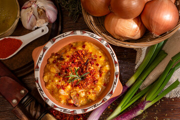 bowl with typical latin american food locro with vegetables and corn on a wooden table