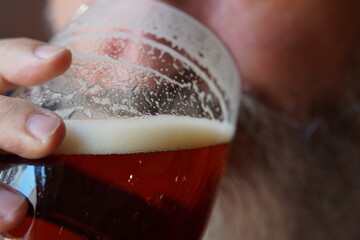 Man drinking beer. Man with beard  having mug of beer in pub