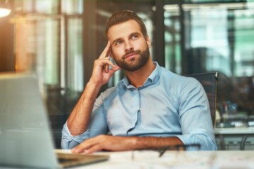 Thinking about business. Young bearded man in formal wear touching his head, smiling and looking...