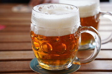 Czech-style Pilsner lager golden beer on table of bar pub restaurant in Prague, Czech Republic.