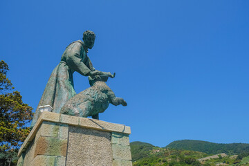 Monument of San Francesco d'Assisi across blue sky from beneath in Monterosso, Liguria, Italy