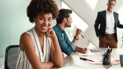 I am happy to work here Young afro american woman is looking at camera and smiling while her boss...