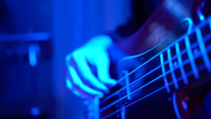 Guitarist playing bass guitar. Slow motion