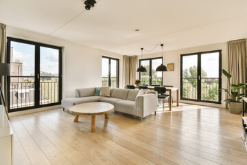 a living room with wood flooring and large sliding glass doors that open onto the balcony...