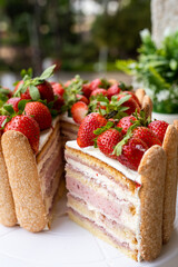 Strawberry tiramisu cake with decorated savoiardi cookies.