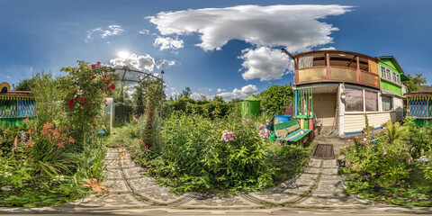 360 hdri panorama view in garden with flower bed yard near wooden eco house or homestead in village...