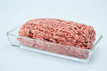 Raw meat ground into minced meat on a white background. Pork, beef or lamb. Different parts of meat...