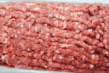 Raw meat ground into minced meat on a white background. Pork, beef or lamb. Different parts of meat products for different dishes.