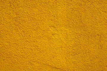 Yellow concrete wall close up background