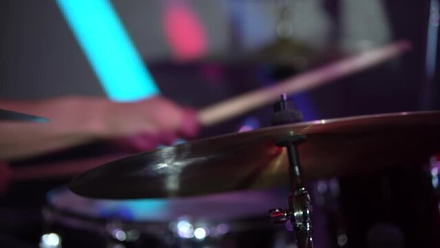 Musician on a drum set at a festive concert. Slow motion