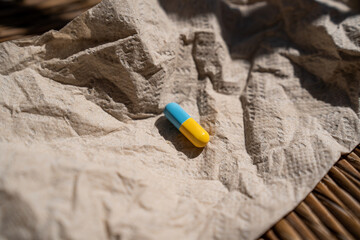 blue yellow pill capsule medicine