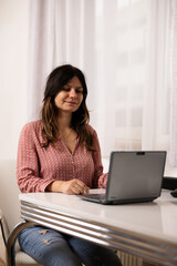 smiling woman looking at laptop