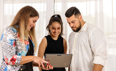 Team working together looking at a tablet