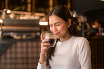 A young woman drinking coffee in modern coffee shop