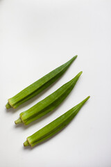 Okra or okro or lady's fingers warm season vegetable on the table. Ingredient of vegan diet.  Good source of minerals, vitamins, antioxidants, and fiber.