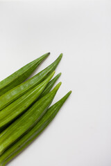 Okra or okro or lady's fingers warm season vegetable on the table. Ingredient of vegan diet.  Good source of minerals, vitamins, antioxidants, and fiber.