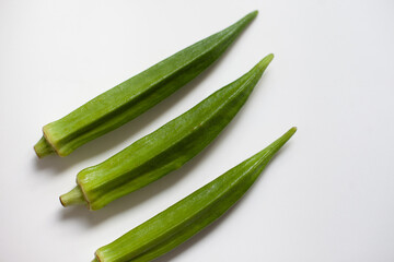 Okra or okro or lady's fingers warm season vegetable on the table. Ingredient of vegan diet.  Good source of minerals, vitamins, antioxidants, and fiber.