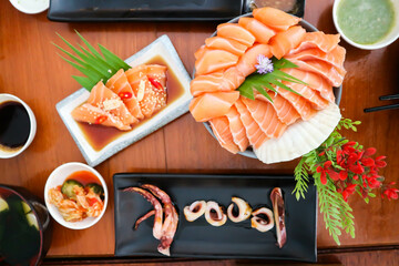 raw salmon, sashimi or sliced salmon and grilled squid