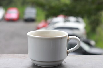 milk black coffee in vintage cup. Soft focus with dramatic light on a blurred background.