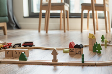 wooden toys on the floor in the nursery, baby in the house, eco-friendly toys on the wooden floor - obrazy, fototapety, plakaty