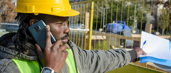banner of black man construction worker talking on the phone solving a problem with the insurer